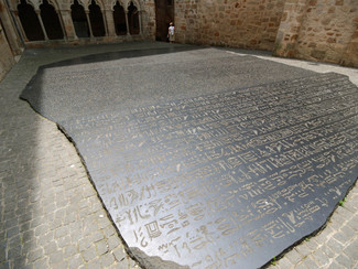 The Rosetta Stone, whose trilingual inscription enabled Champollion to translate the ancient Egyptian hyroglyphs, in the courtyard of the museum in Figeac in a replica.